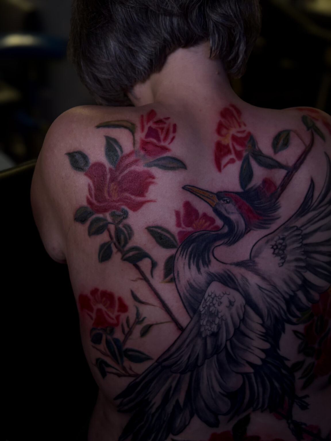 tattoo artist working on back tattoo healing process skin tattooing art nouveau