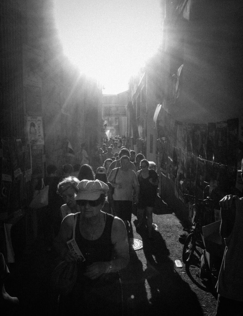 Avignon street packed with crowd during the Festival, summer atmosphere black and white