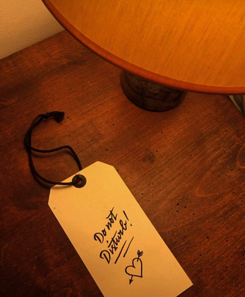 Do Not Disturb sign on wooden table at Hôtel Amour Nice
