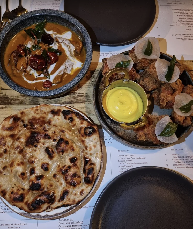 Curry, naan and fried chicken with turmeric sauce at Kricket Soho London