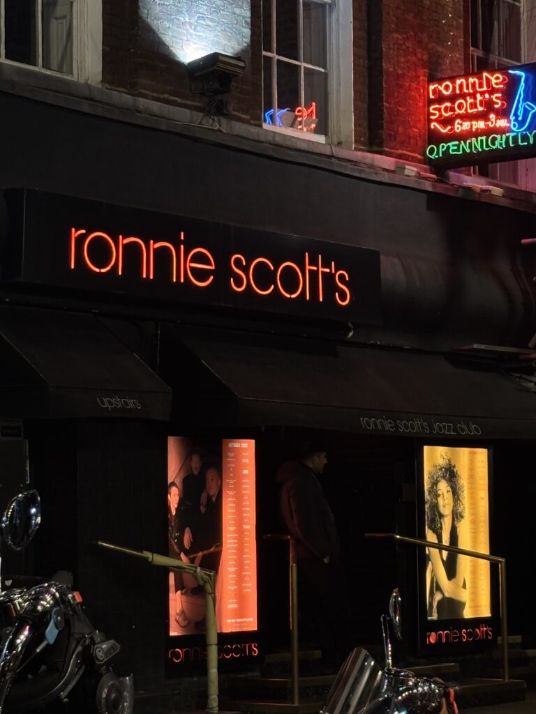 onnie Scott's Jazz Club facade at night in Soho London, red neon sign