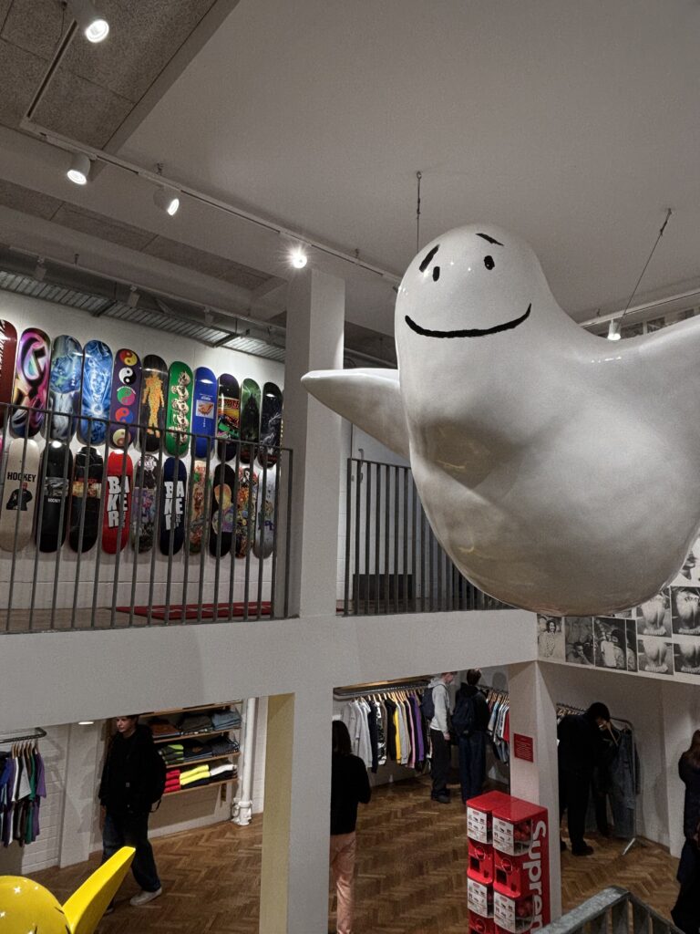 Inside Supreme Soho London, giant ghost sculpture suspended above skateboard wall