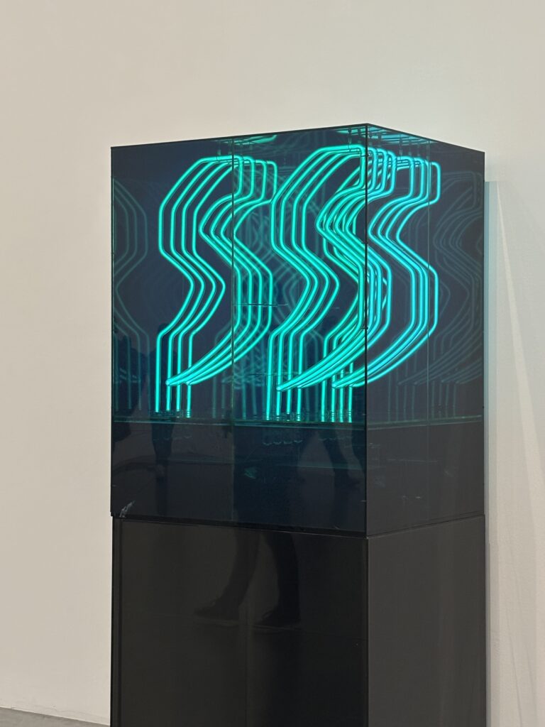 Turquoise neon sculpture in glass box at Tate Modern London, contemporary art