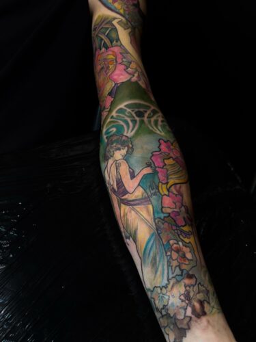 Full colour Art Nouveau sleeve inspired by Alphonse Mucha, feminine figure and flowers, Tamara Chaudesaigues tattoo artist London