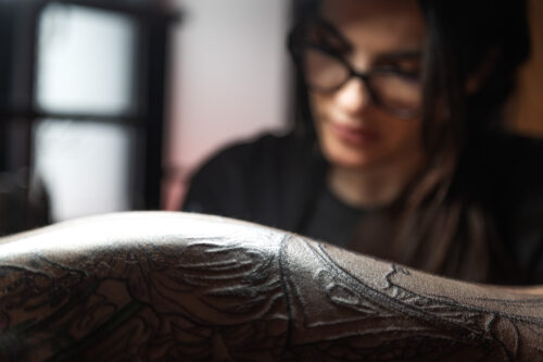 Tamara Chaudesaigues tattooing close up, Art Nouveau composition on skin, tattoo artist London