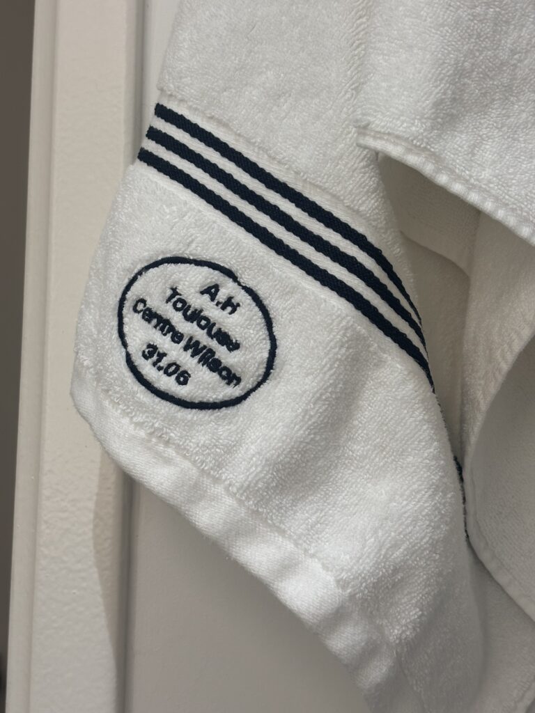 White striped embroidered towel at Alfred Hotels Toulouse