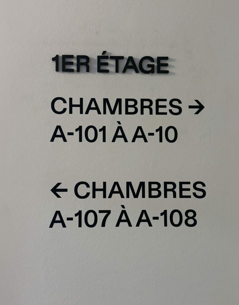 Large black letters of the signage in the hotel corridors
