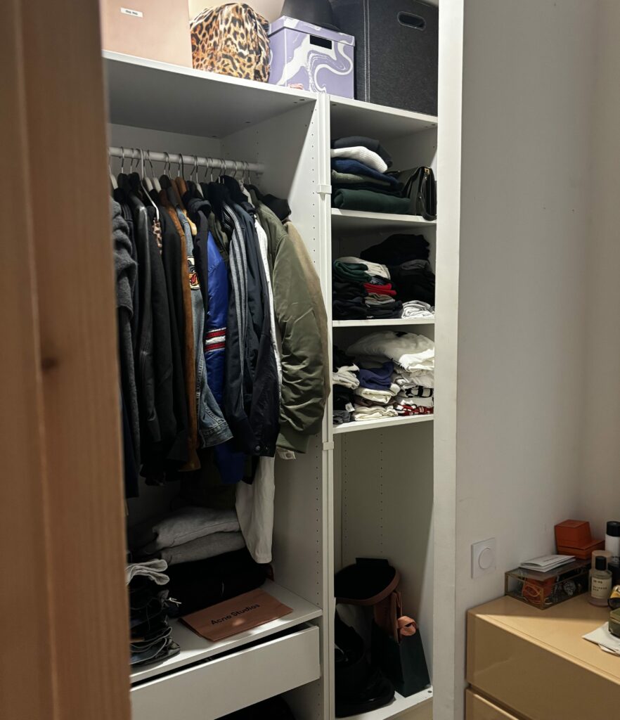 An organised wardrobe with autumn clothes, jeans and jackets