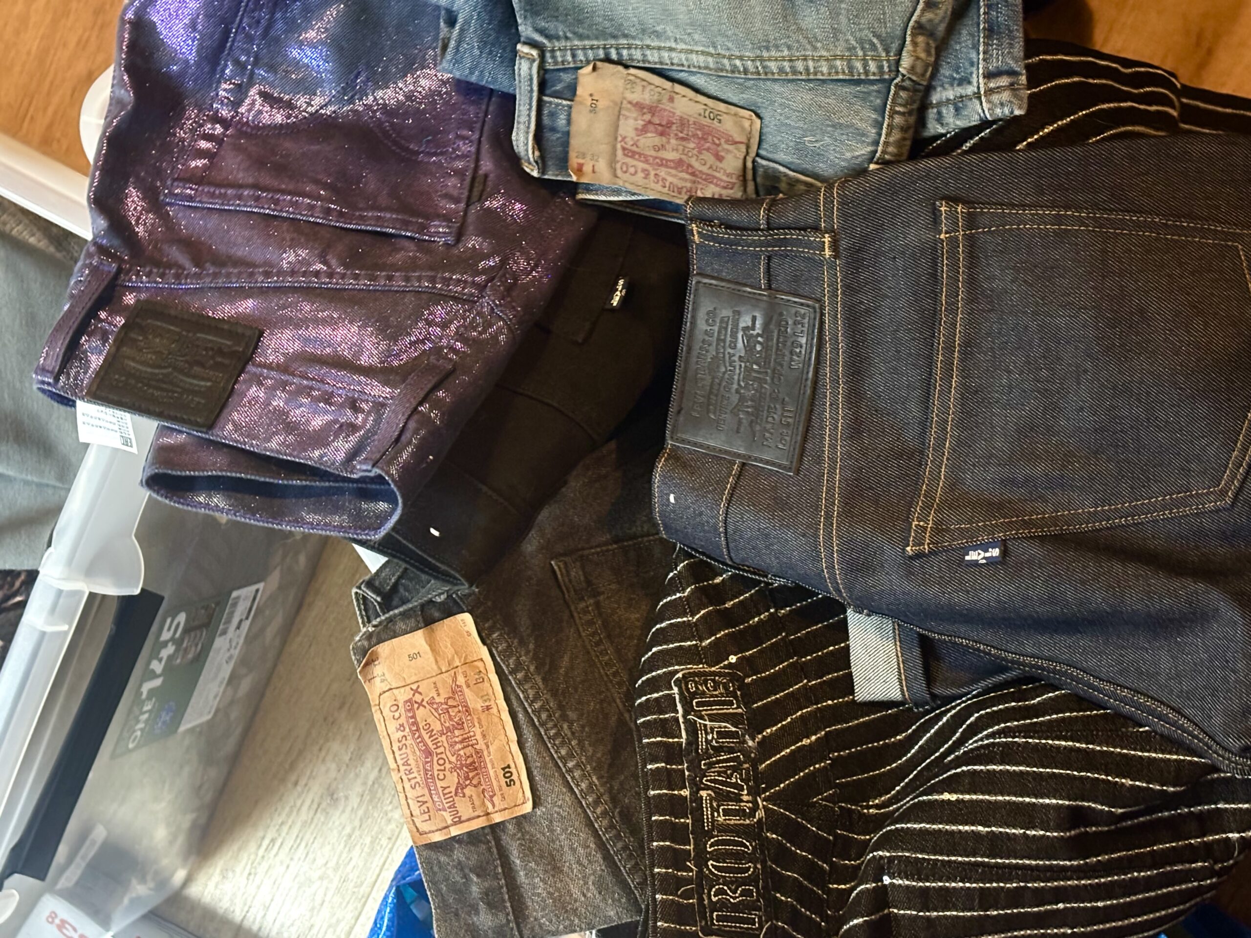 A stack of Levi’s jeans and other trousers sorted before moving house