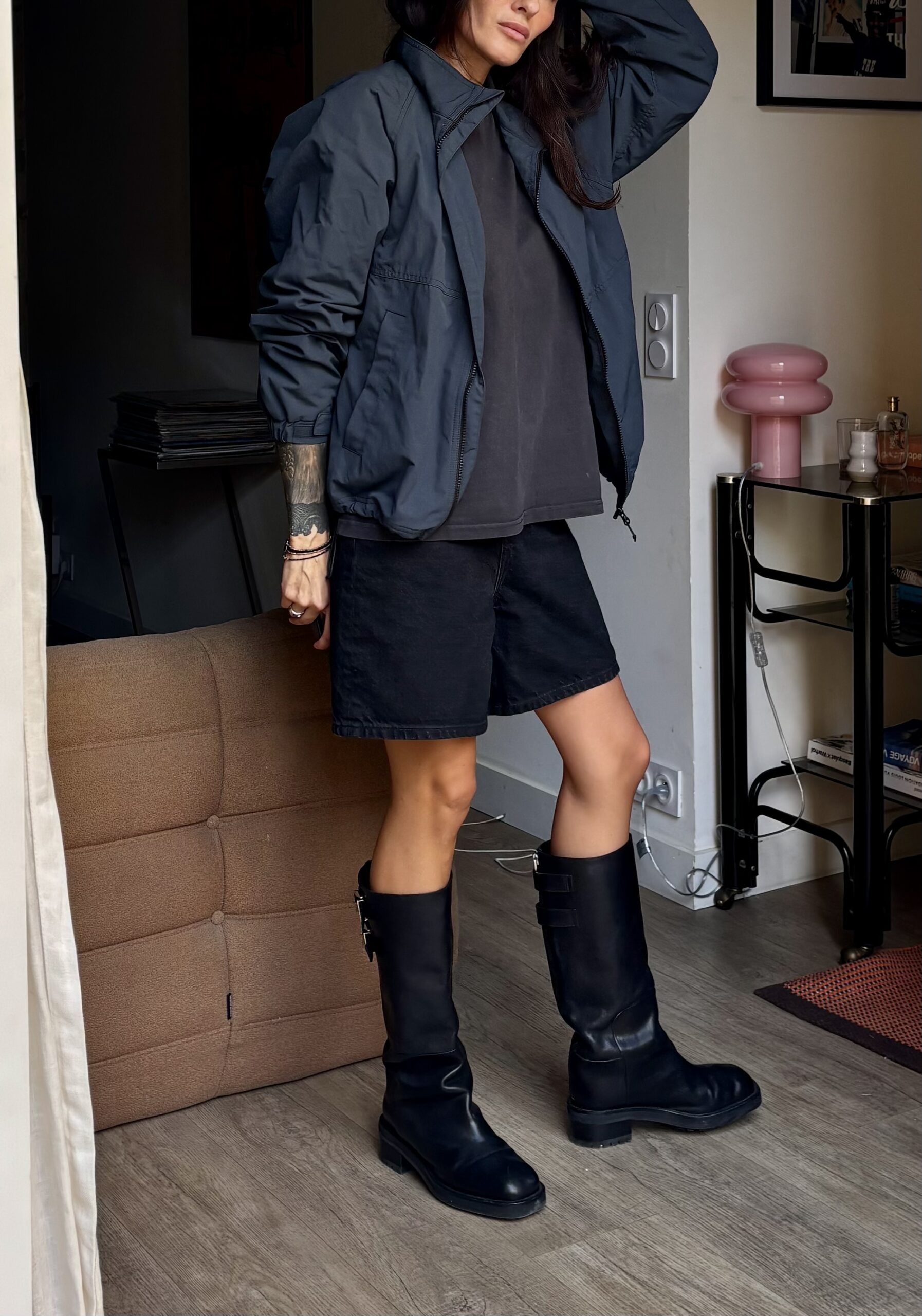 Tamara Chaudesaigues wearing a navy jacket, black shorts and Jimmy Choo boots for an autumn outfit
