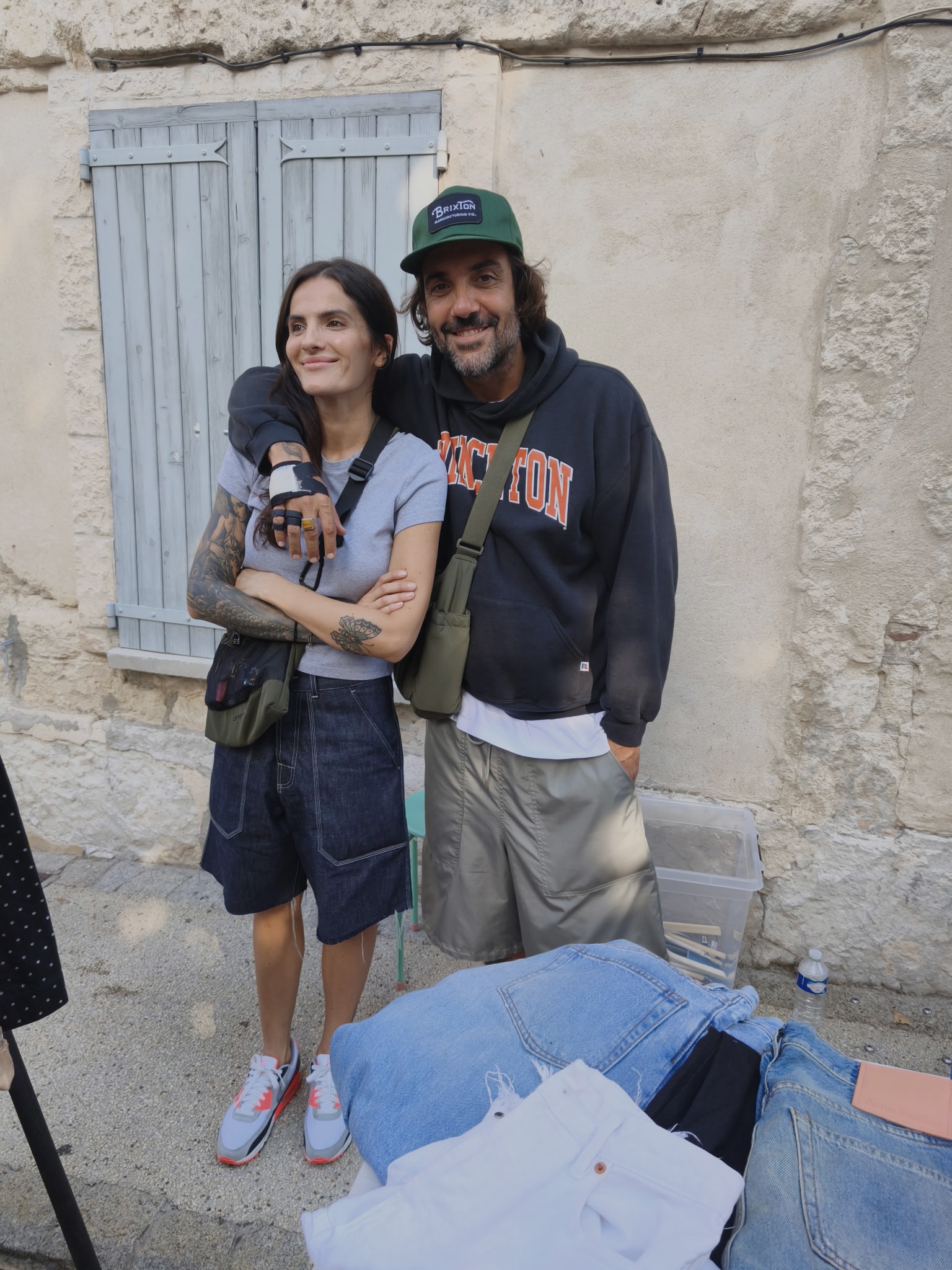 Tamara Chaudesaigues and Greg at the Villeneuve flea market with clothes for sale