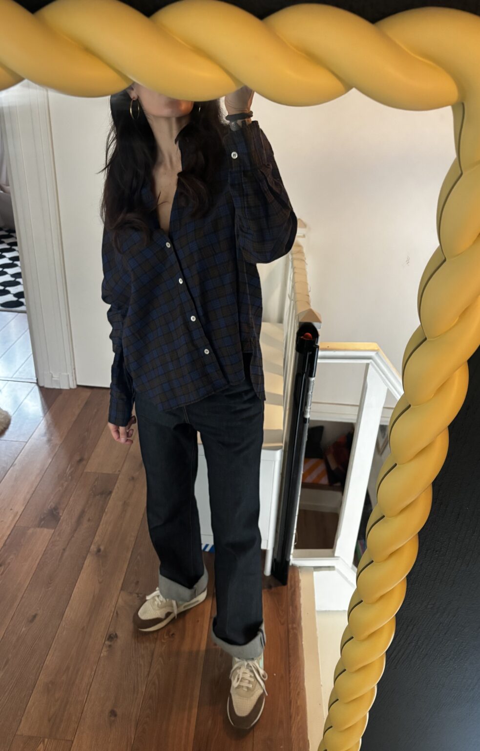 Tamara Chaudesaigues wears a women's Bsbee plaid shirt with Saint Laurent jeans and Nike Air Max 1 Crepe Hemp sneakers.